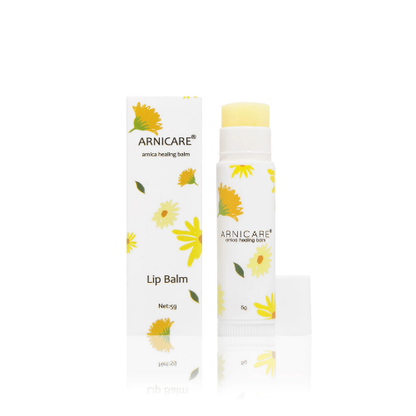 Arnicare lip balm with packaging on a white background