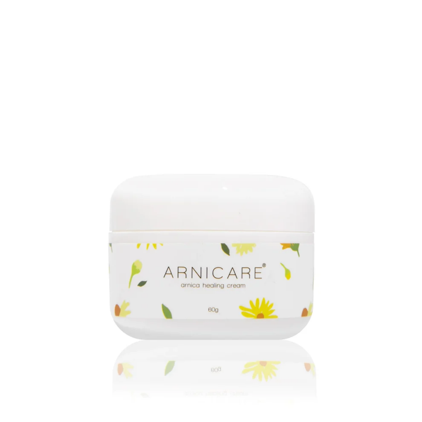A white plastic jar of ARNICARE arnica healing cream with a white lid, decorated with small yellow flowers and green leaves, set against a solid white background with a soft reflection below.