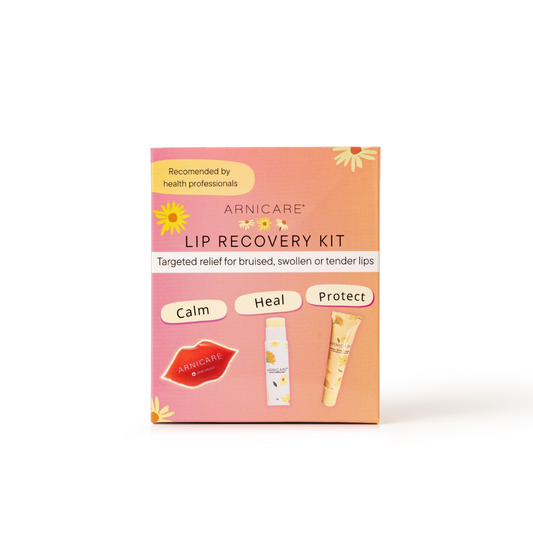 A boxed lip recovery kit labeled ARNICARE LIP RECOVERY KIT, shown upright on a clean white background. The package is peach and pink with floral accents and three illustrated tubes labeled Calm, Heal, and Protect.